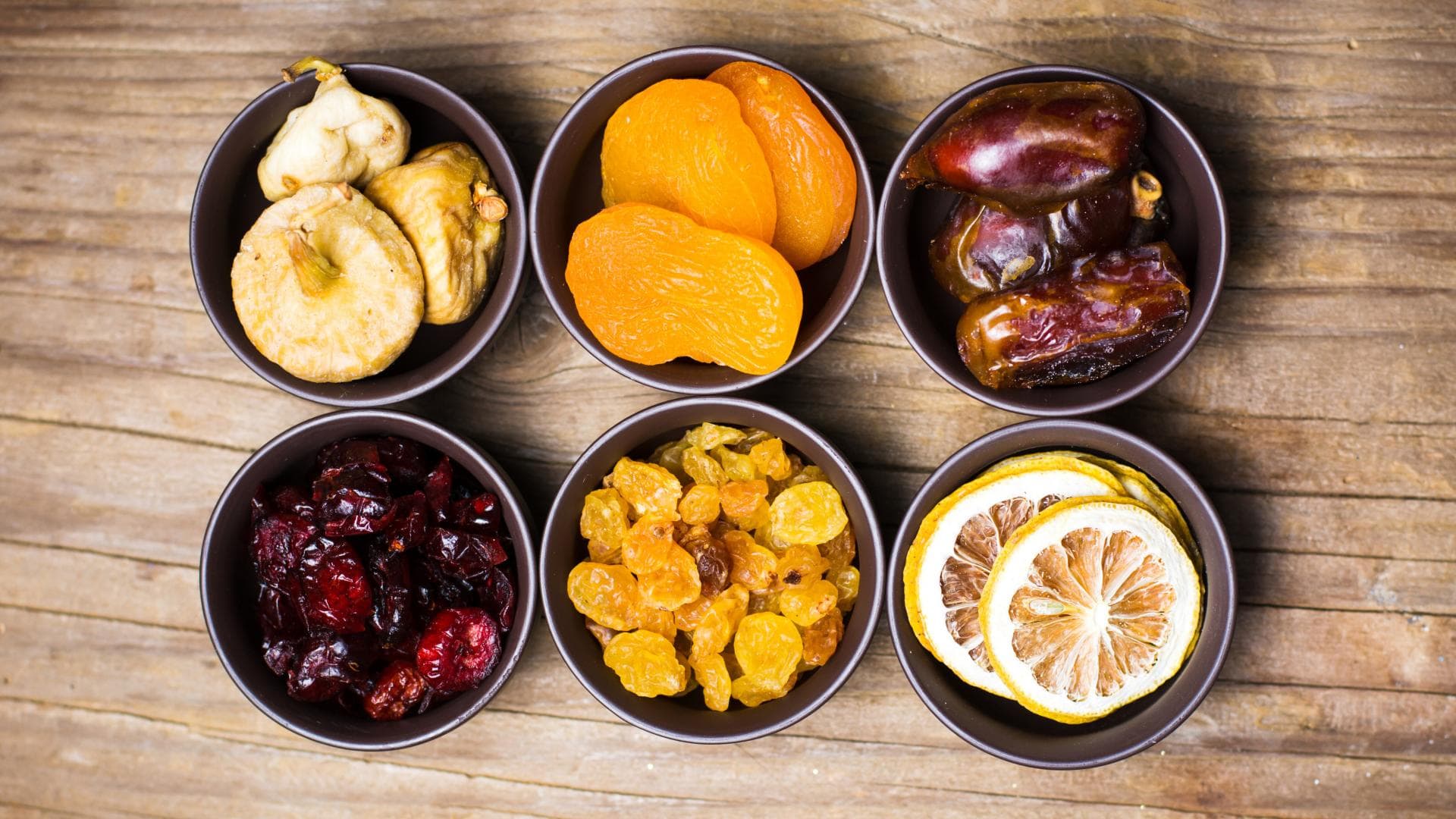 Various dried fruits in small bowls top view zuckersucht