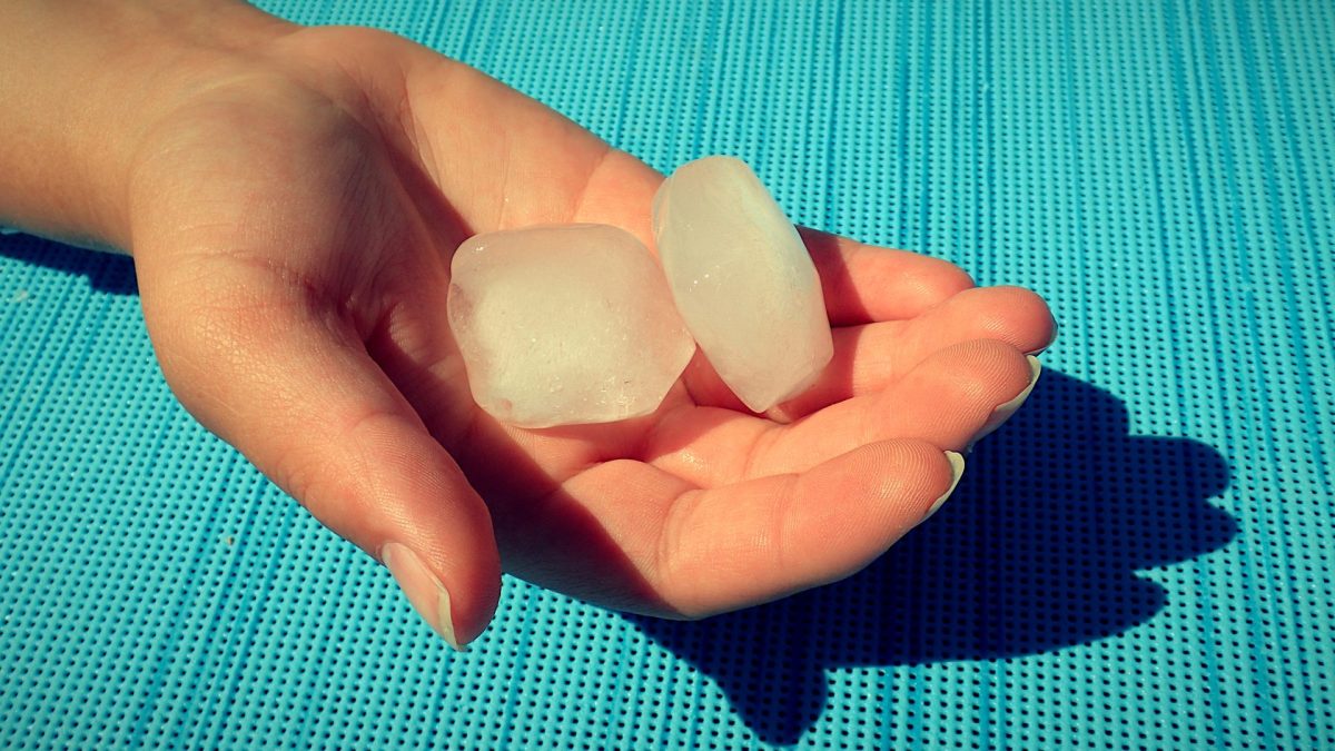 Eiswürfel in der Hand einer Frau