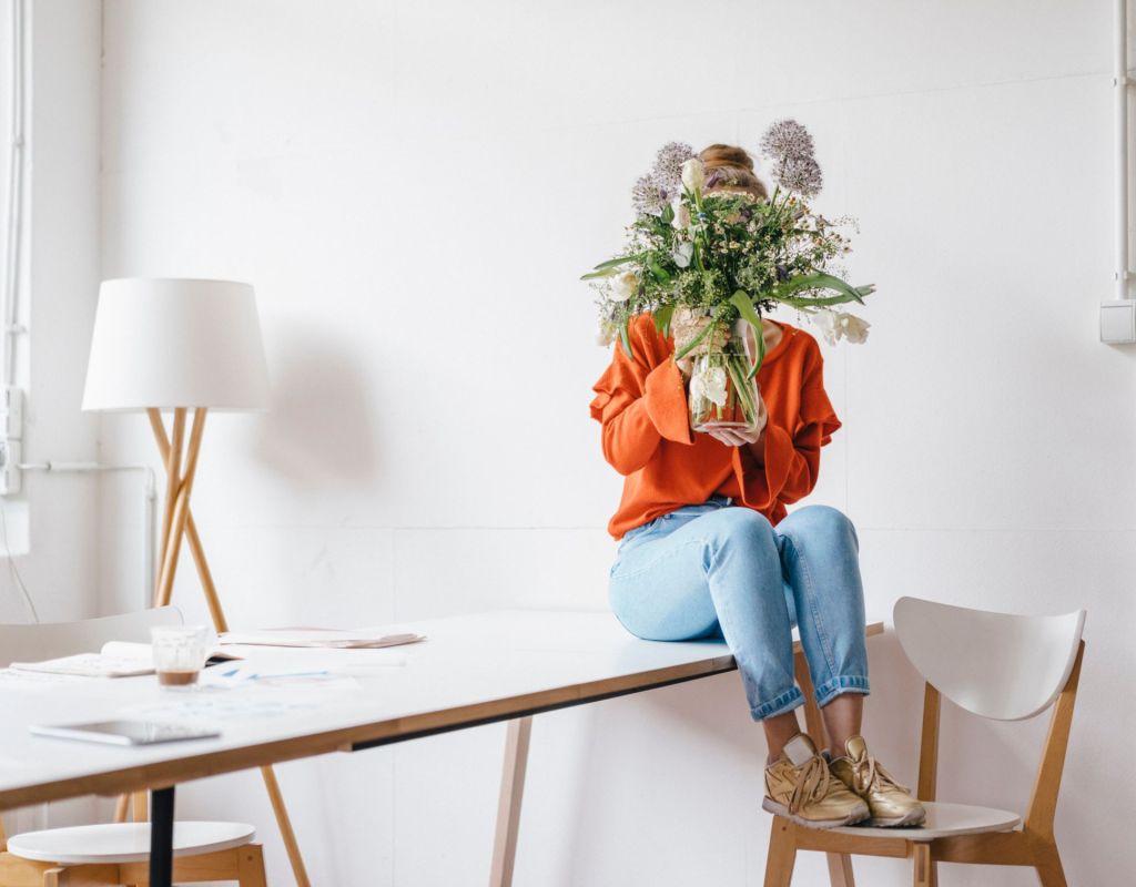 Jobs für Introvertierte Frau versteckt sich hinter Blumenstrauß