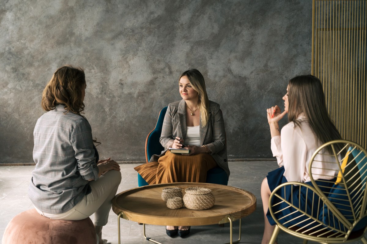 FÃ¼hrungskraft: Drei GeschÃ¤ftsfrauen unterhalten sich im BÃ¼ro.