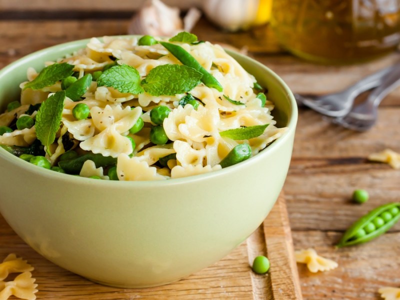 Pfefferminz-Farfalle in grÃ¼ner SchÃ¼ssel auf Holztisch.