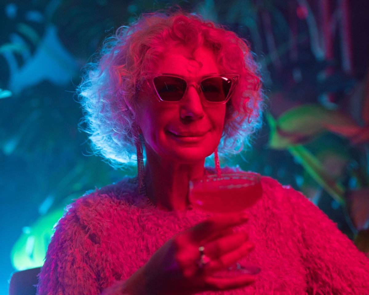 Oma trinkt aus einem Cocktail-Glas