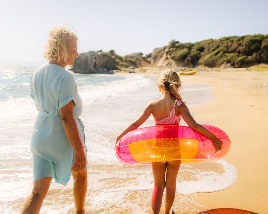 Oma mit ihrer Enkelin am Strand